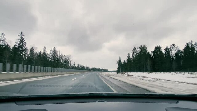 driving in a car along the highway to the port of Ust-Luga on a spring day