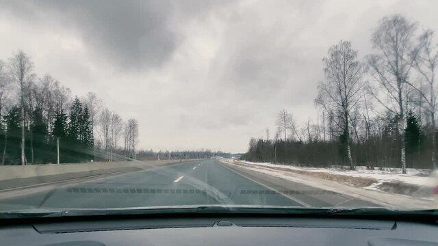 driving in a car along the highway to the port of Ust-Luga on a spring day