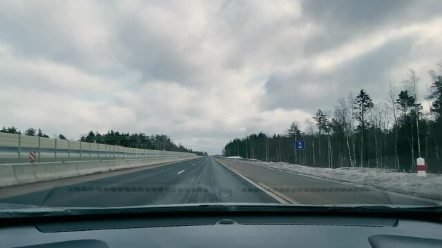 driving in a car along the highway to the port of Ust-Luga on a spring day