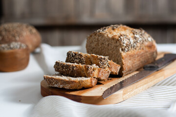 Selective focus. Slices of homemade wholemeal seed bread with a rustic background.