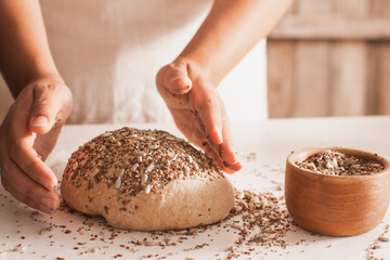 Woman placing seeds to whole wheat bread