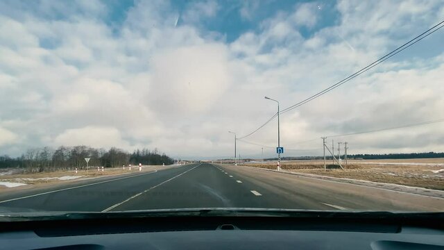 driving in a car along the highway to the port of Ust-Luga on a spring day