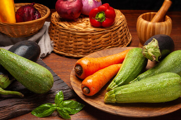 assorted vegetables on wooden table wicker basket and pepper mortar still life style of vegetables