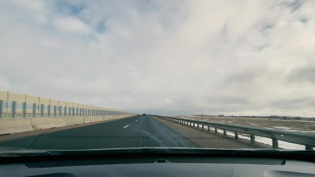 driving in a car along the highway to the port of Ust-Luga on a spring day