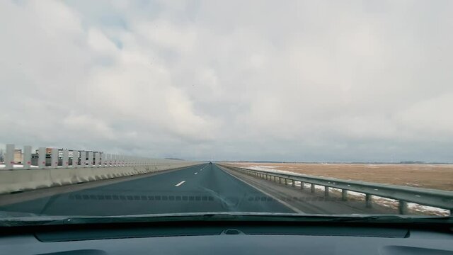driving in a car along the highway to the port of Ust-Luga on a spring day