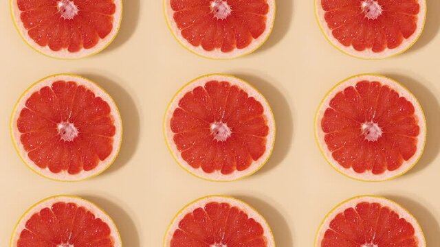 Half sliced citrus grapefruit pattern rotating. Stop motion flat lay