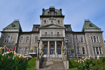 Fototapeta na wymiar Townhall historical building. Sherbrooke, Quebec city hall front view. Green copper roof details