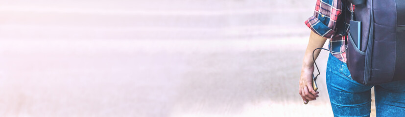Banner, Power bank in the girl s hand, against the background of the forest and the road.