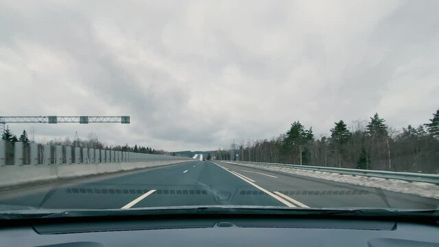 driving in a car along the highway to the port of Ust-Luga on a spring day