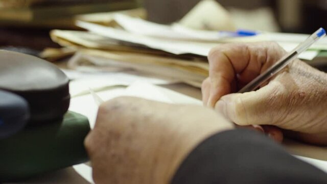 Hand Of An Elderly Man With A Pen Writing. - Close Up Shot