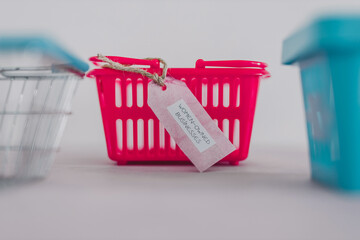 women-owned businesses tag with pink shopping basket among competitor blue ones, supporting equality