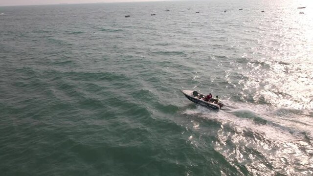 goa Sinquerim Candolim Beach drone bird's eye view boat jet in seawater following.