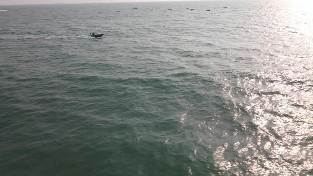 goa Sinquerim Candolim Beach drone bird's eye view boat jet in seawater.