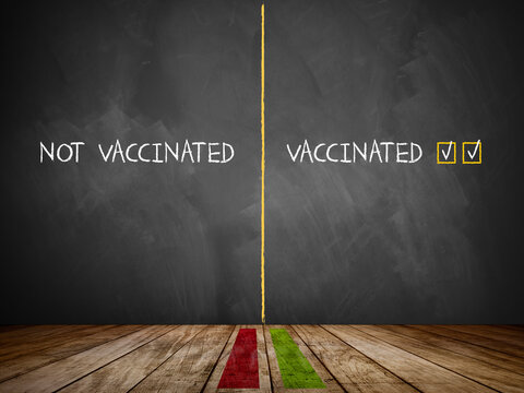 message VACCINATED - NOT VACCINATED on a blackboard