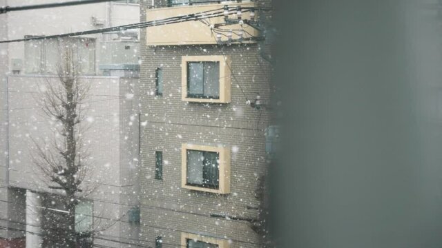 Snowy day in suburban Tokyo shot in slow-motion.