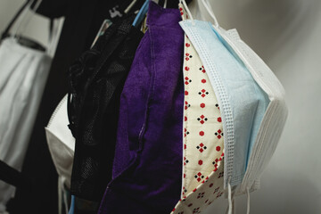 multiple face masks hanging to stroll