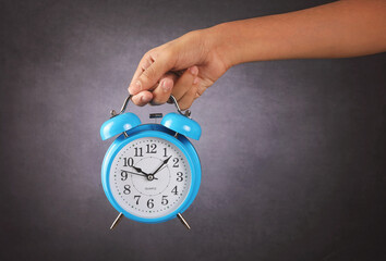 Portrait of Indian boy holding  Alarm Clock