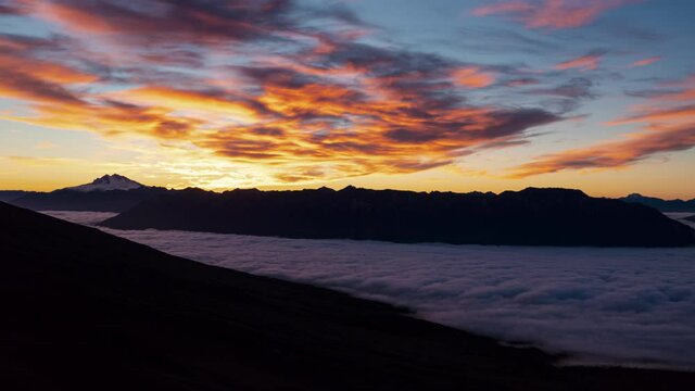 Time-lapse of the sun setting over the National Park Vicente Perez Rosales, golden orange sky.