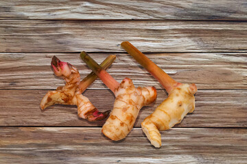 Fresh Ginger roots on wooden background