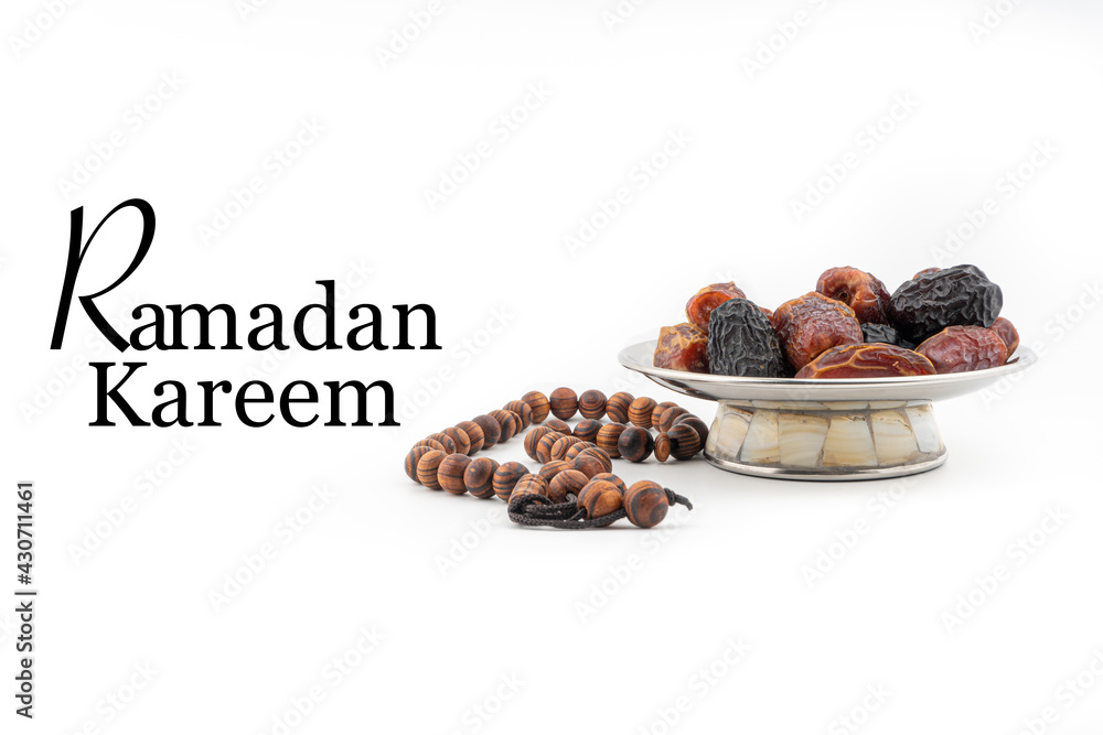 Sticker RAMADAN KAREEM text with Dates or kurma fruits and rosary beads or Tasbih on white background. Ramadan Kareem and Islamic Concept