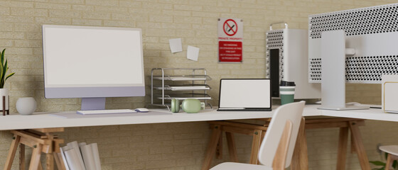 Comfortable office desk with computer, laptop, office supplies, decorations and no smoking sign on the wall, 3D rendering