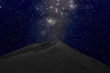 Wonderful bright stars in blue sky over sand mountain