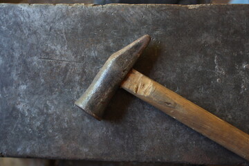 Cutlery hammer on an anvil.