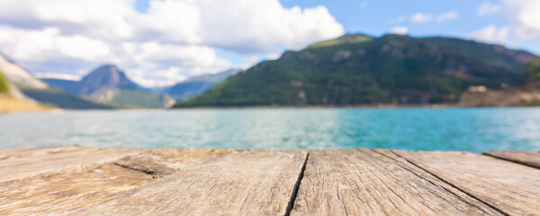 Panoramic view from wooden pier to mountains and azure lake. Beautiful summer landscape with selective focus. Taurus Canyon, Turkey.