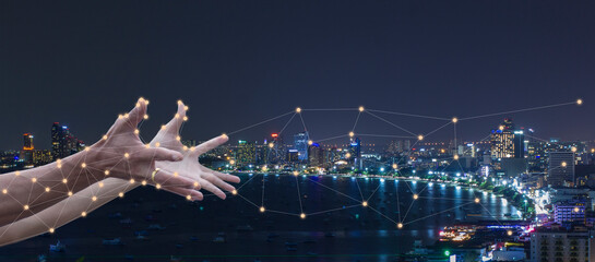 Abstract social digital network connection and communication concept with hand network and city background
