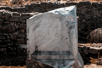 Close-up of a part of the wall, an obelisk with the inscription Patros in the ancient ruined city among the ruins. Side, Turkey.