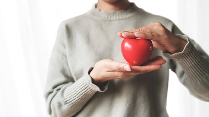 Red heart on the girl hand. Symbol of support that expresses love. Caring, Valentine day and world heart day, heart health concept