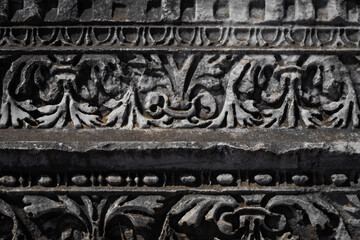 Close-up pattern on antique stone column.Elements of ancient Greek architecture  . Detail of the facade of the city building