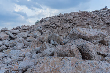 Concrete debris pile mountain in the construction site with blue sky background