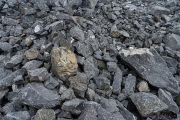 A pile of black pebbles in the construction site.