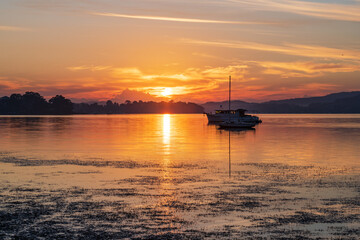 Sunrise waterscape with boats and soft colour