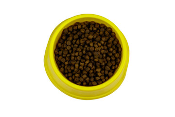 Dry food for cat or dog in a bowl. Top view. Pet food isolated on white background