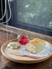 Top view closed up of Plain scone with fruit jam on wood table. Cafe concepta