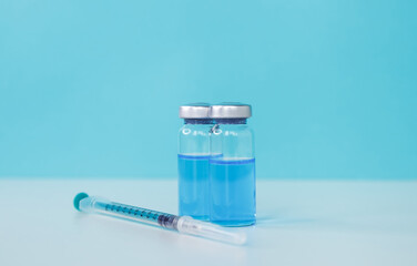 Healthcare and medical concept. Medicine vials and syringe. Covid-19 vaccination background. Coronavirus vaccine bottles and syringe injection. Doctor preparing the vaccine. A vaccine against disease.