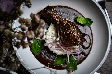 Mexican mole with chicken legs and steamed rice - obrazy, fototapety, plakaty