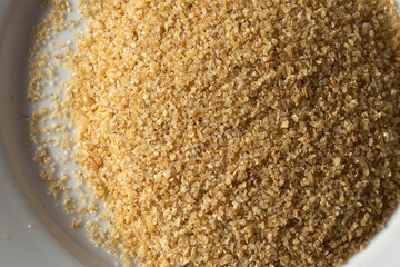 A close-up view of bulgur wheat in warm light.