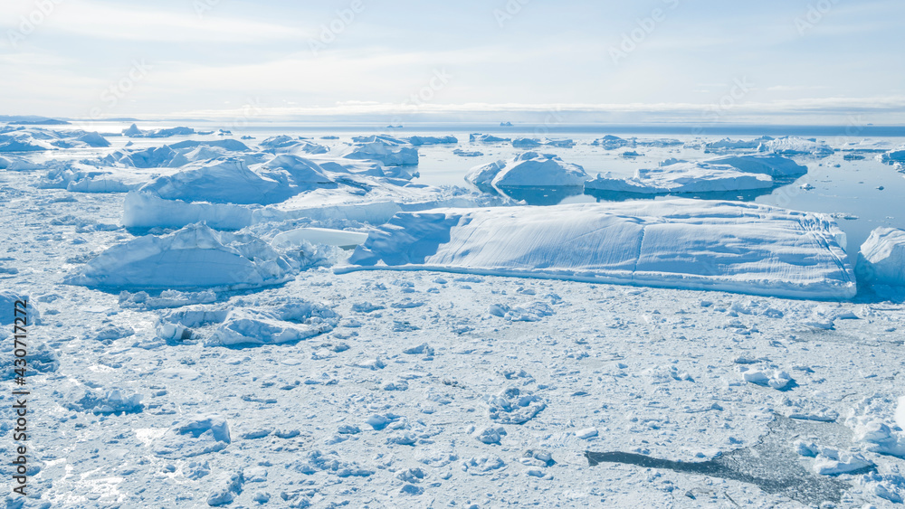 Wall mural climate change. iceberg afrom glacier in arctic nature landscape on greenland. icebergs in ilulissat