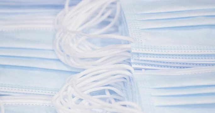 Pile Of Blue Medical Masks, Pandemic Protection - closeup tilt down