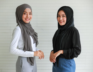 Smiling Muslim women in office outfit and hijabs