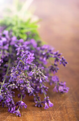 Branch of a lavenderon a wooden table