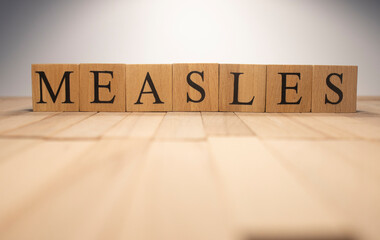 The word Measles was created from wooden cubes. Health and life Close up.