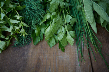 fresh herbs on wooden surface