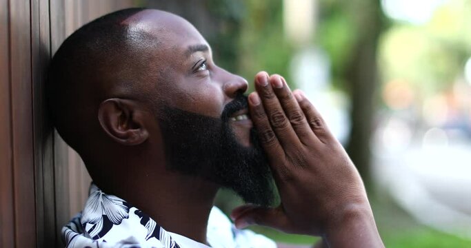 Positive African man feeling spiritual and happy. Hopeful and faithful person