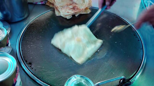 
Roti Making, roti thresh flour by roti maker with oil. Indian traditional street food. Thai Pancake Banana And Egg . Thai Street Food and Desserts. Making of roti snack