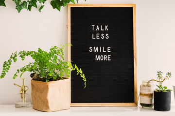 letterboard with the message, talk less smile more