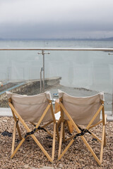 Empty two camp chairs on the beach.